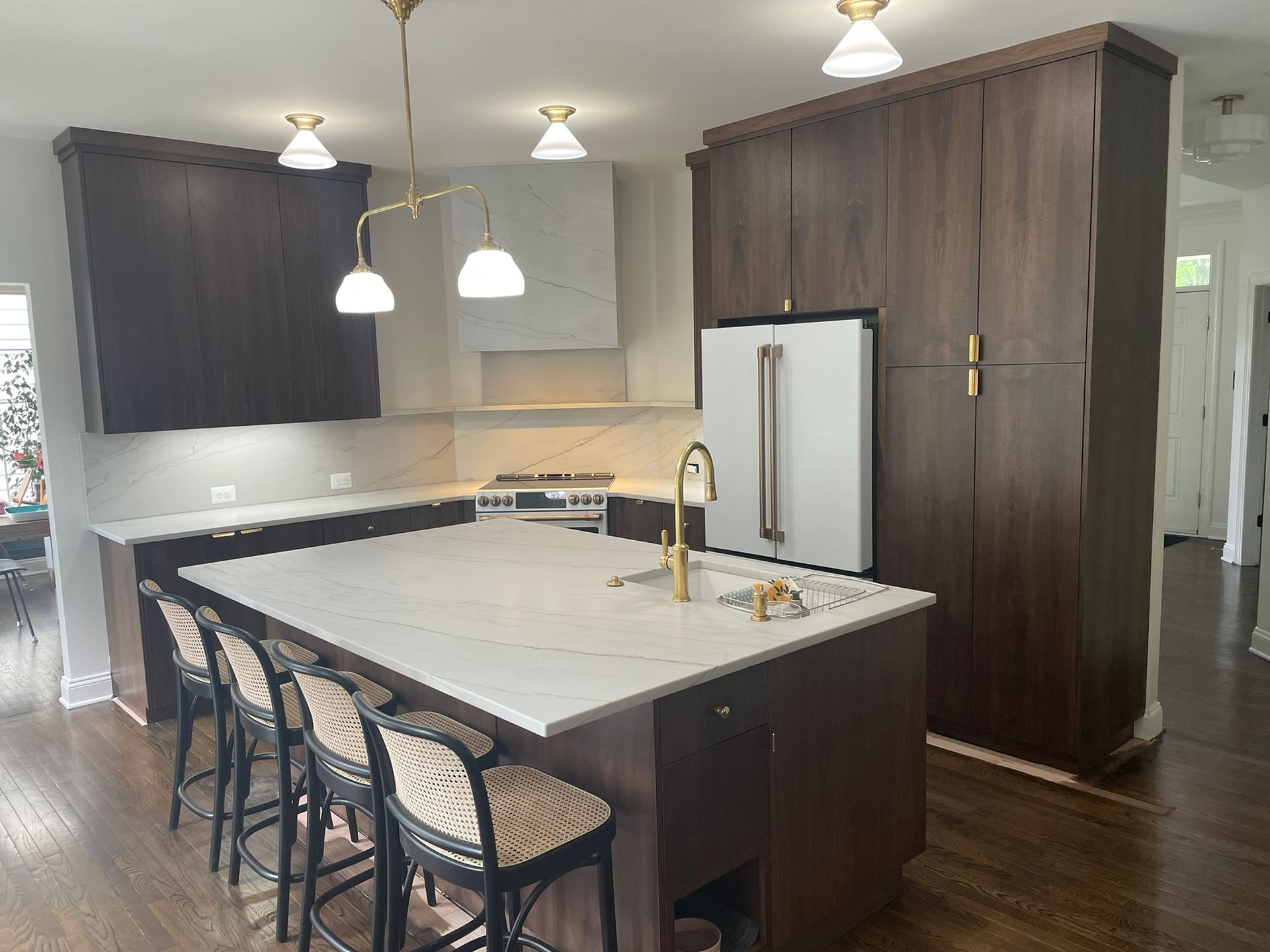 A kitchen with white cabinets and stainless steel appliances