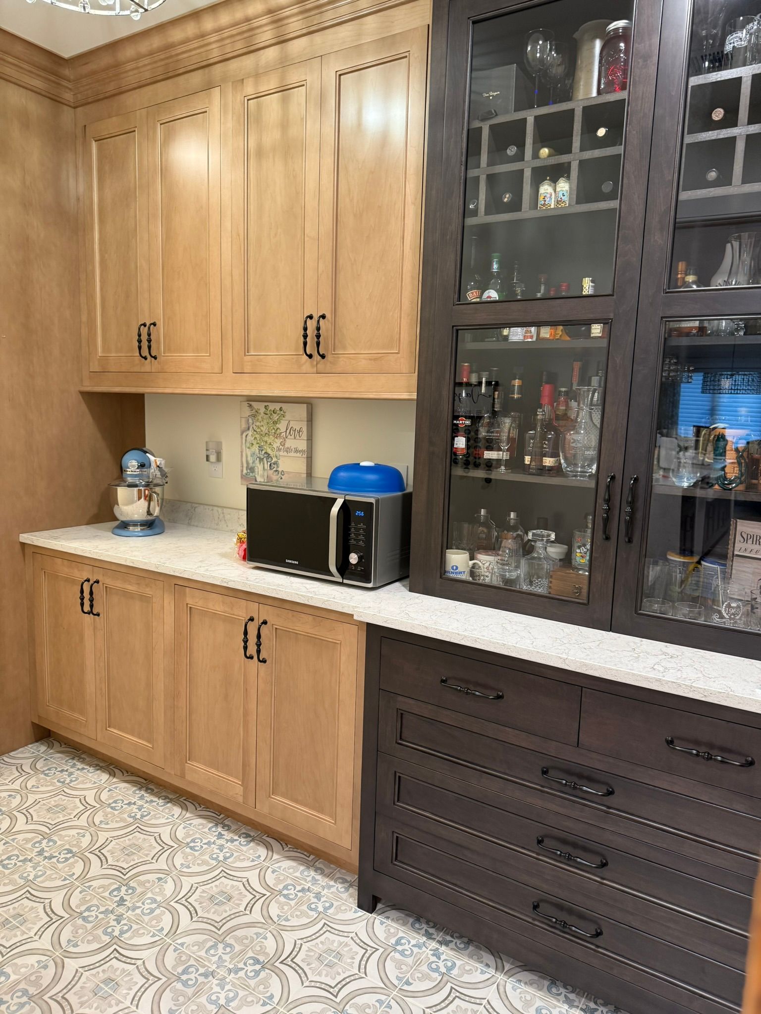 A kitchen with white cabinets and a large island
