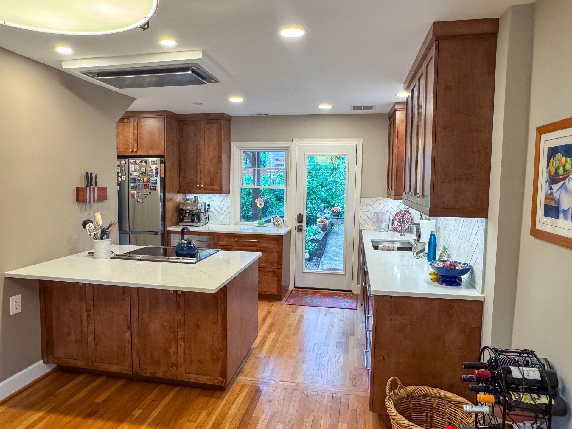 A kitchen with wooden cabinets and white counter tops