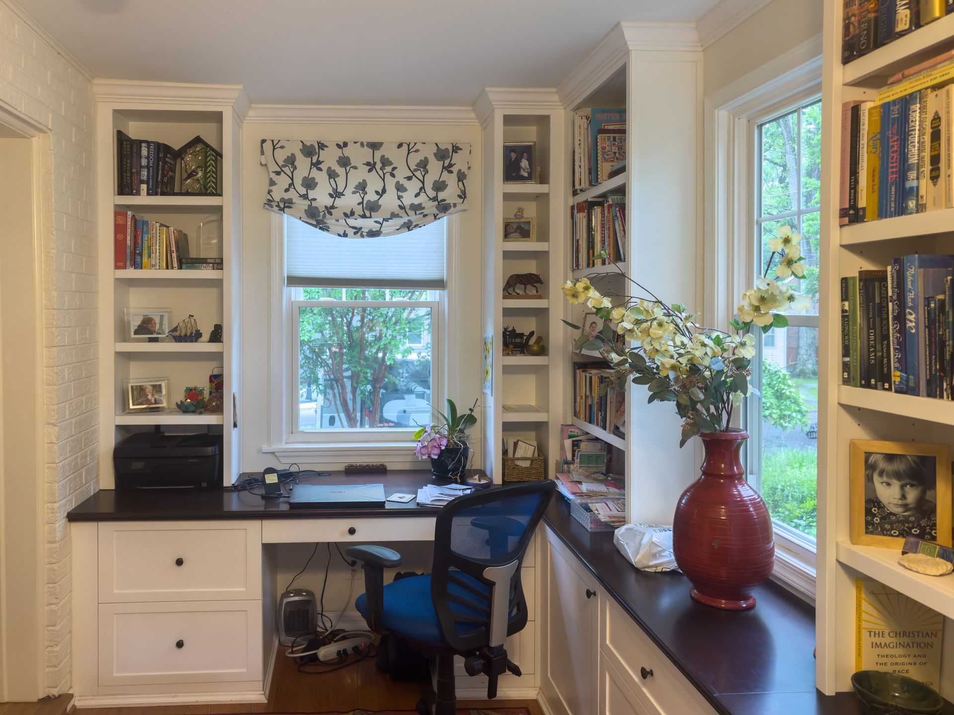 A living room with lots of shelves and a flat screen tv