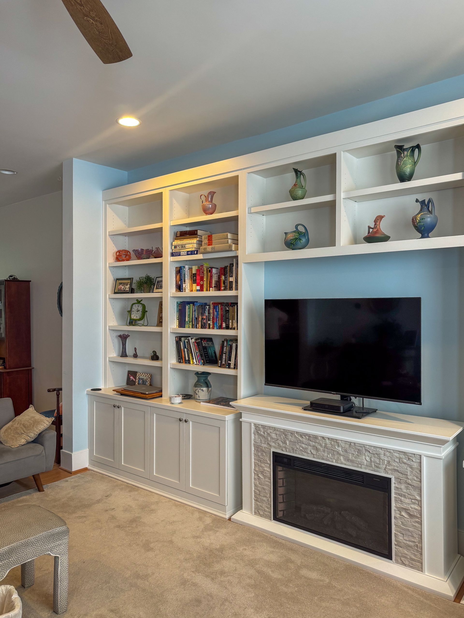 A living room with a large flat screen tv on the wall