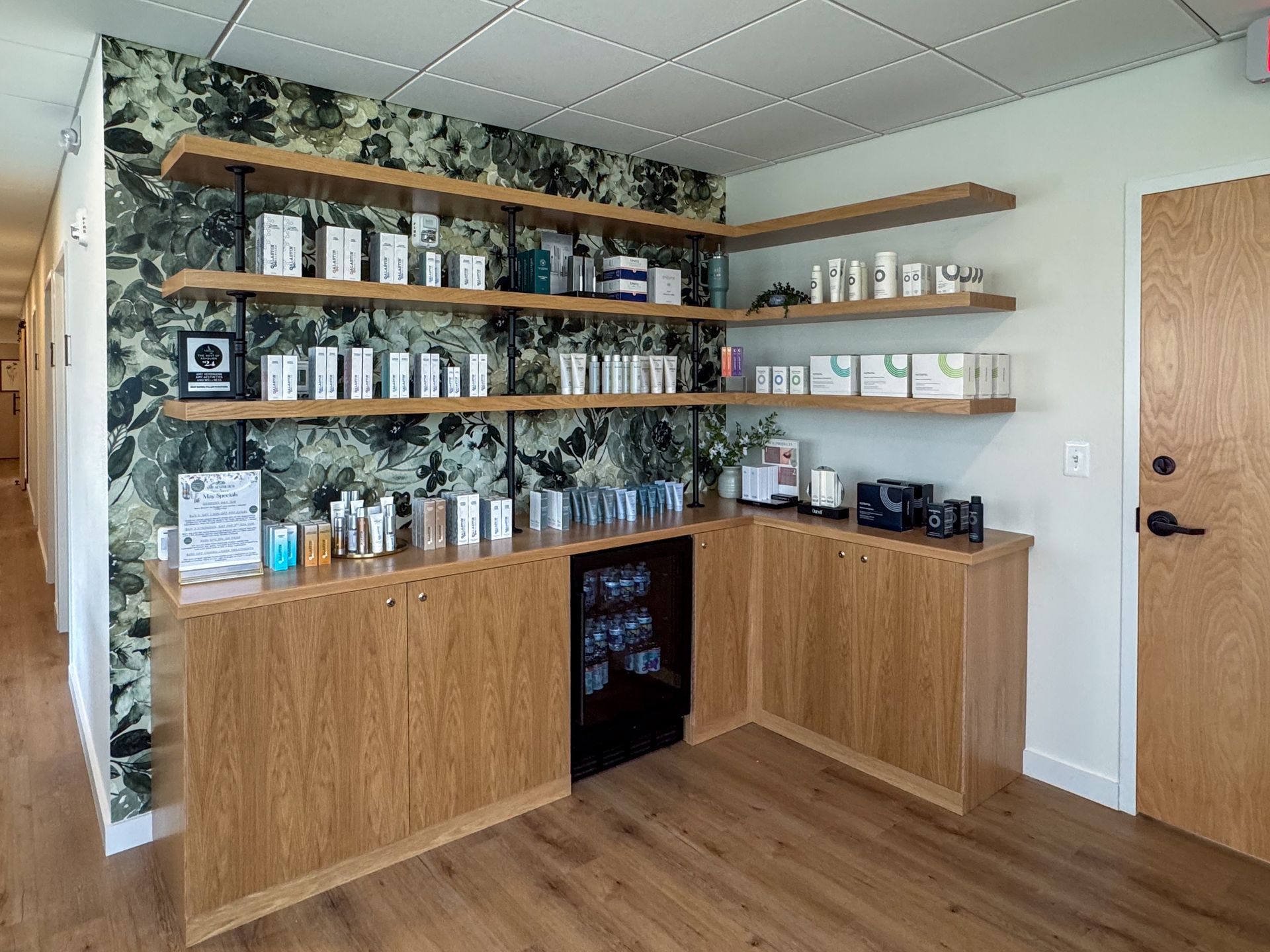 A room with wooden cabinets and shelves filled with beauty products