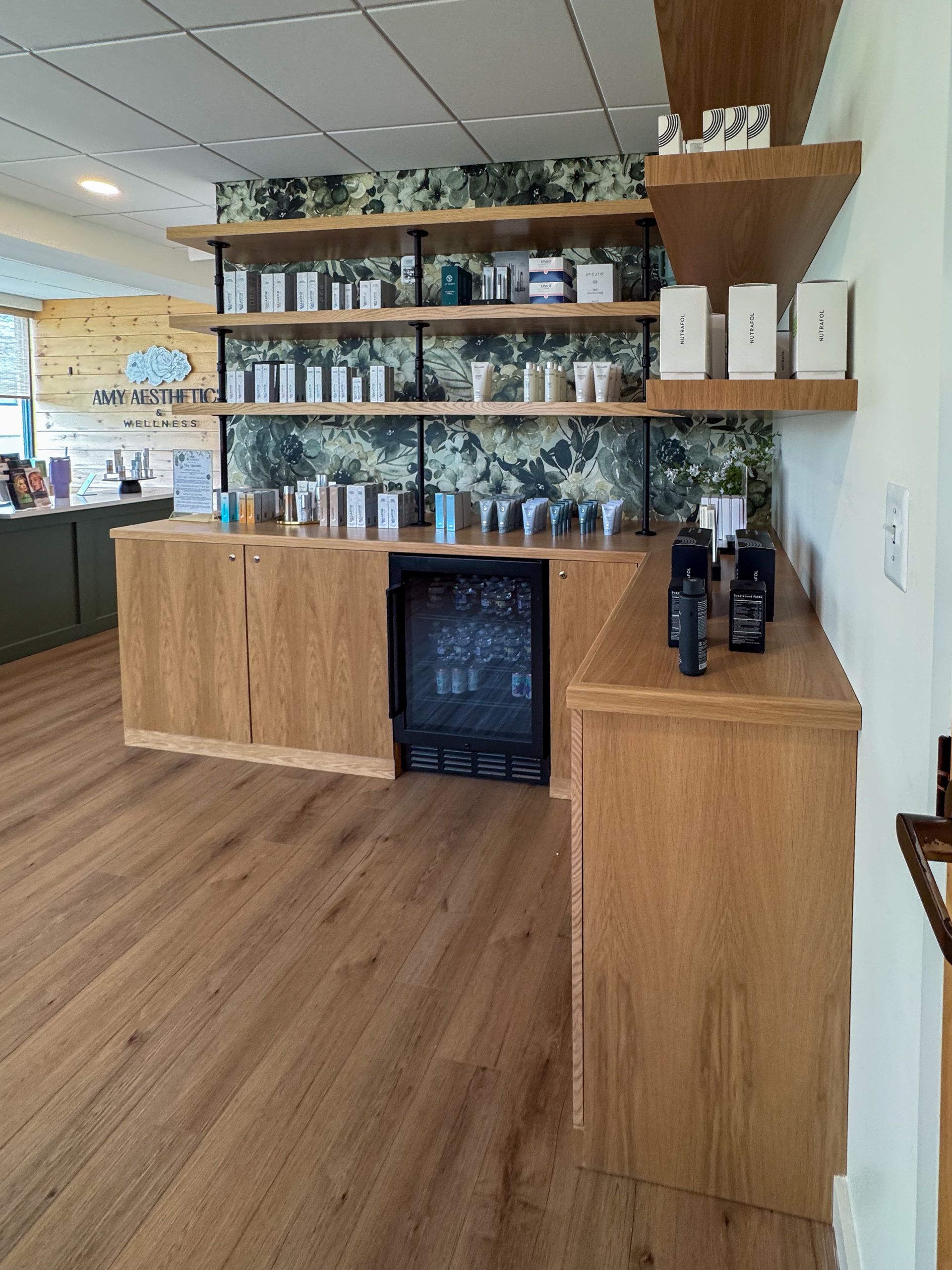 A room with wooden shelves and a wine cooler