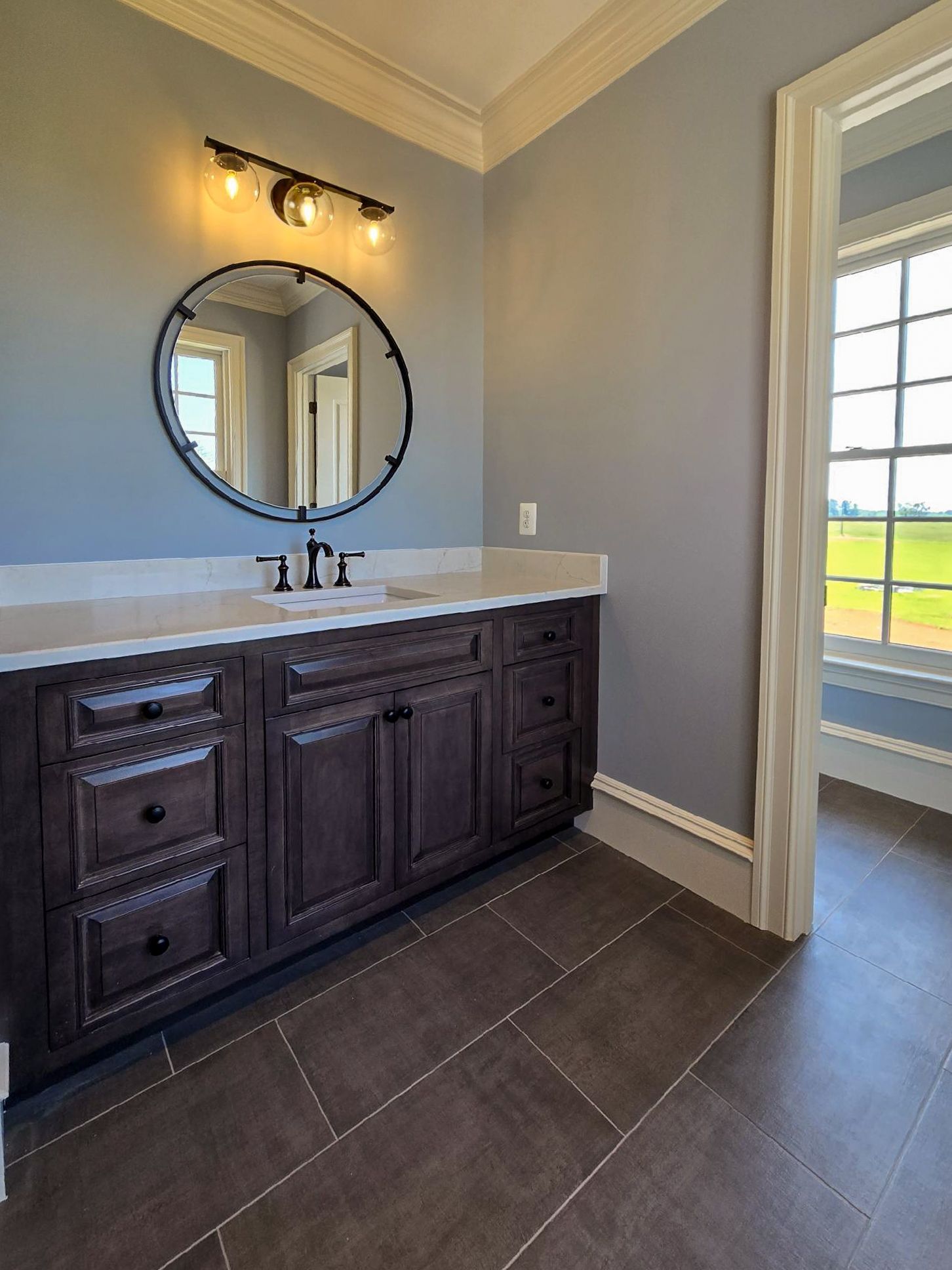 A bathroom with two sinks and black counter tops