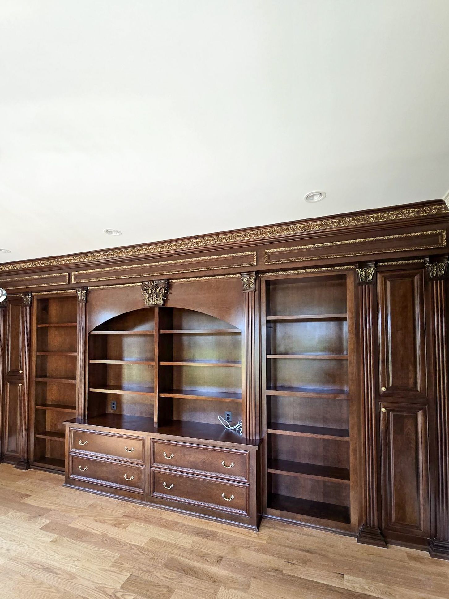 A room with lots of wooden shelves and drawers