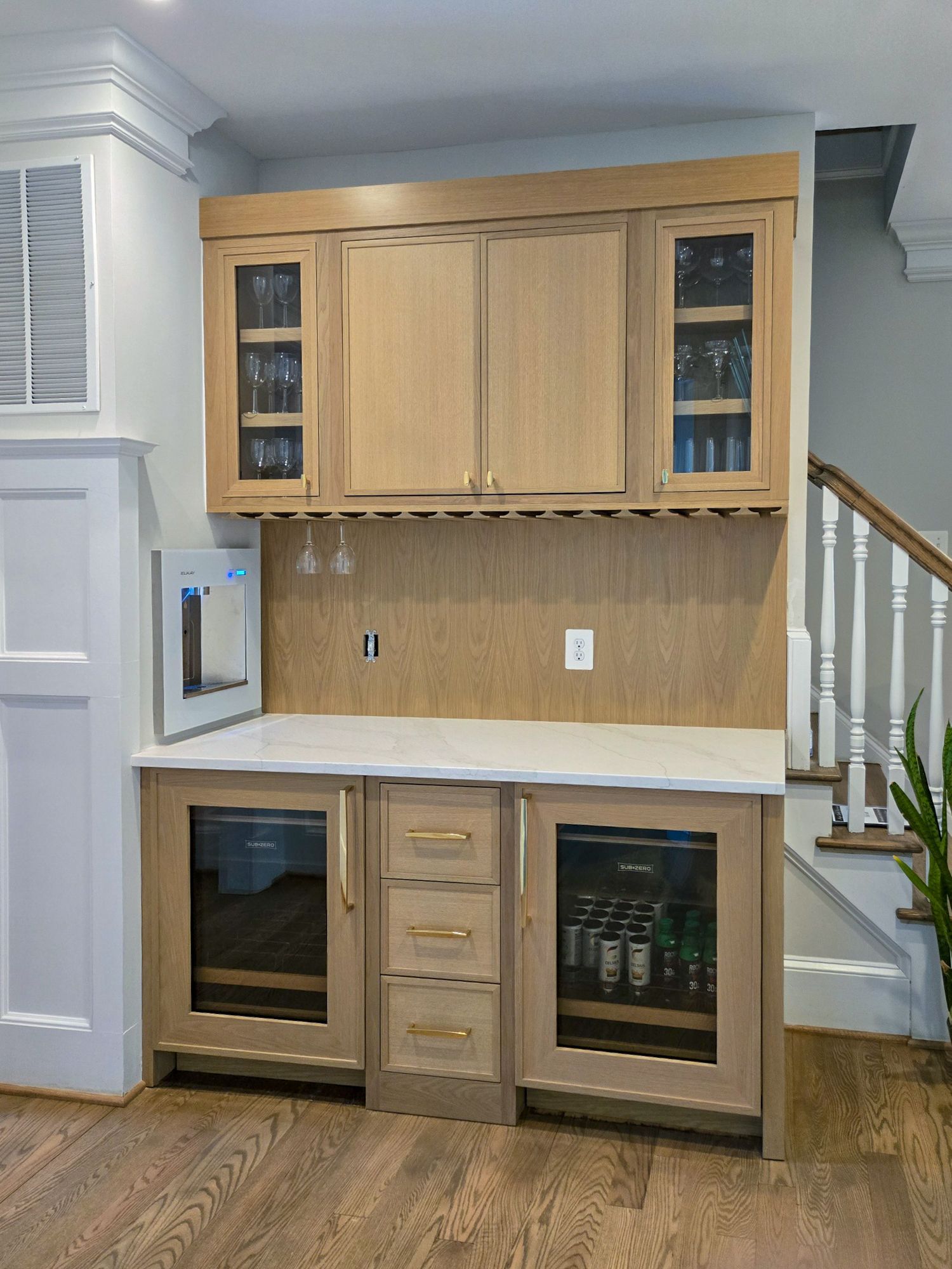 A kitchen with white cabinets and a stainless steel refrigerator