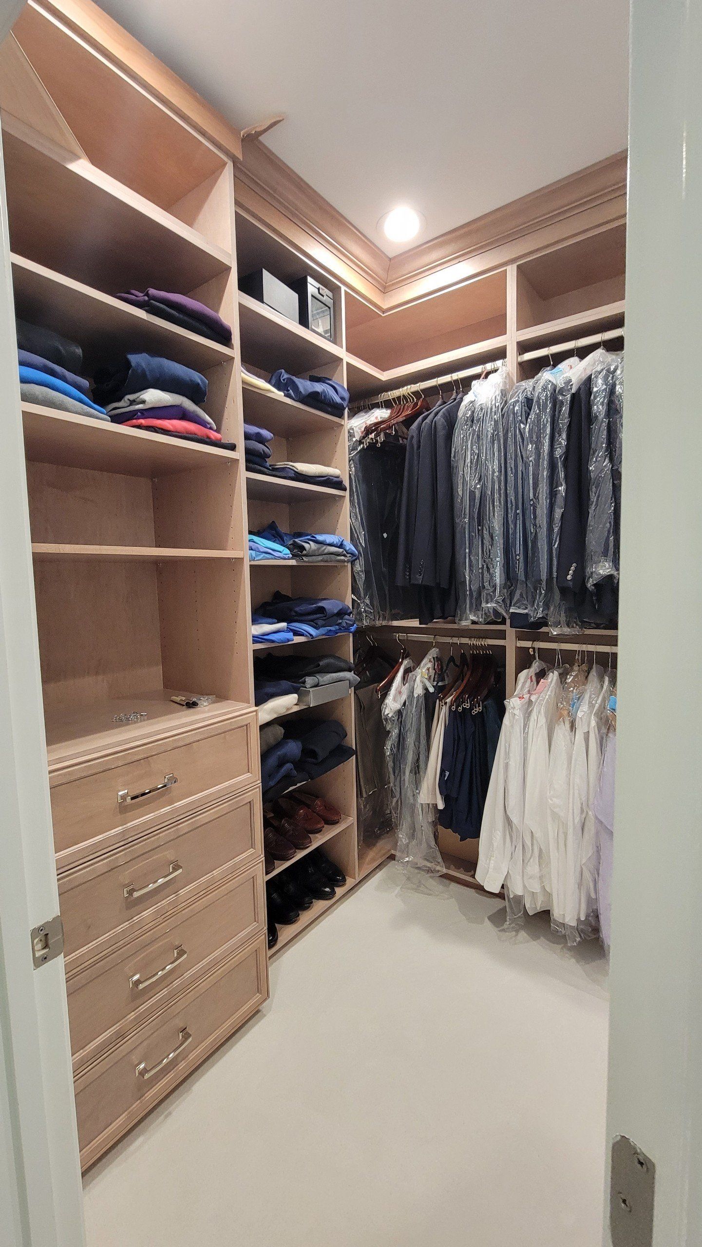A walk in closet filled with clothes and shoes