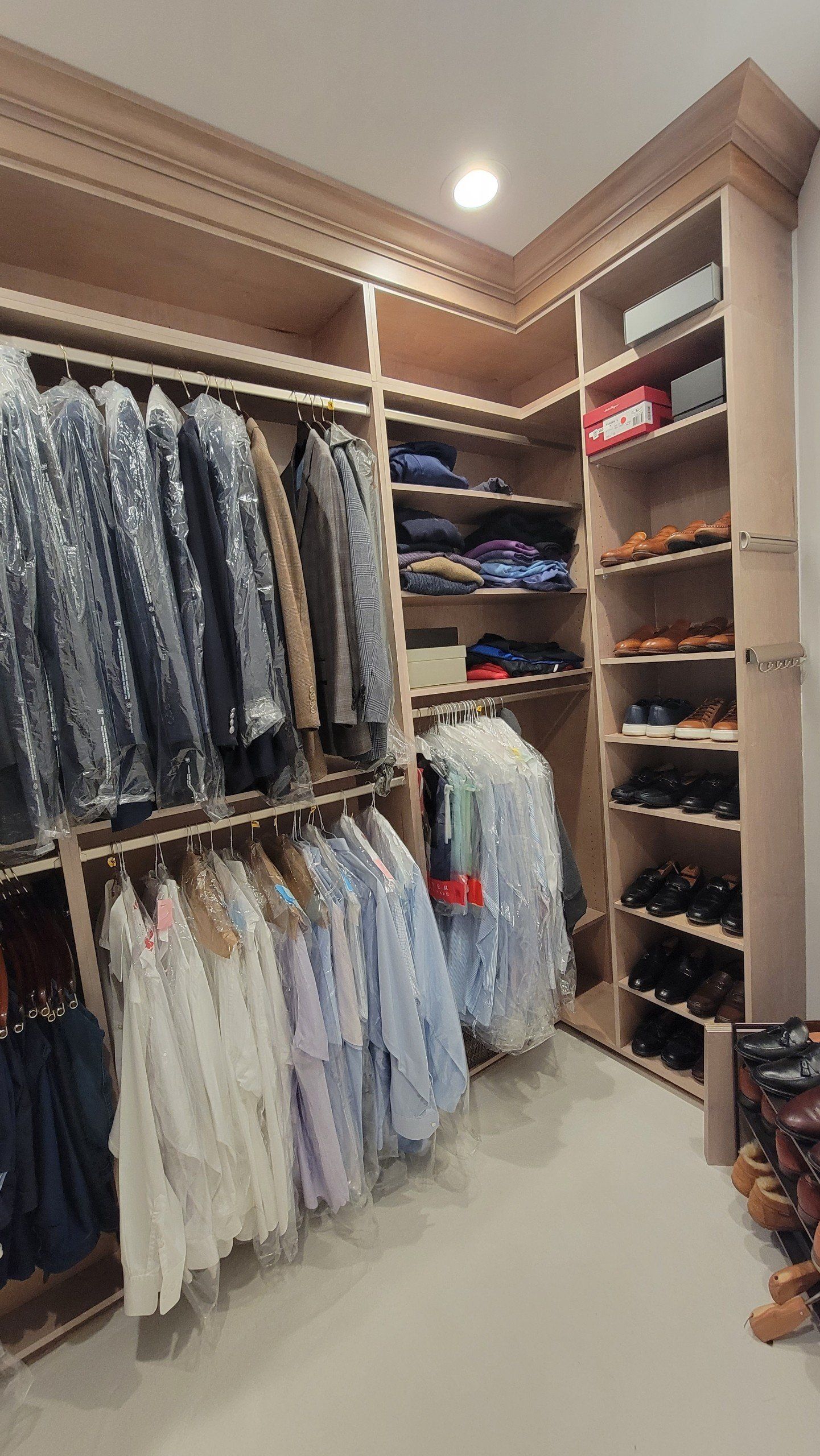 A walk in closet filled with clothes and shoes
