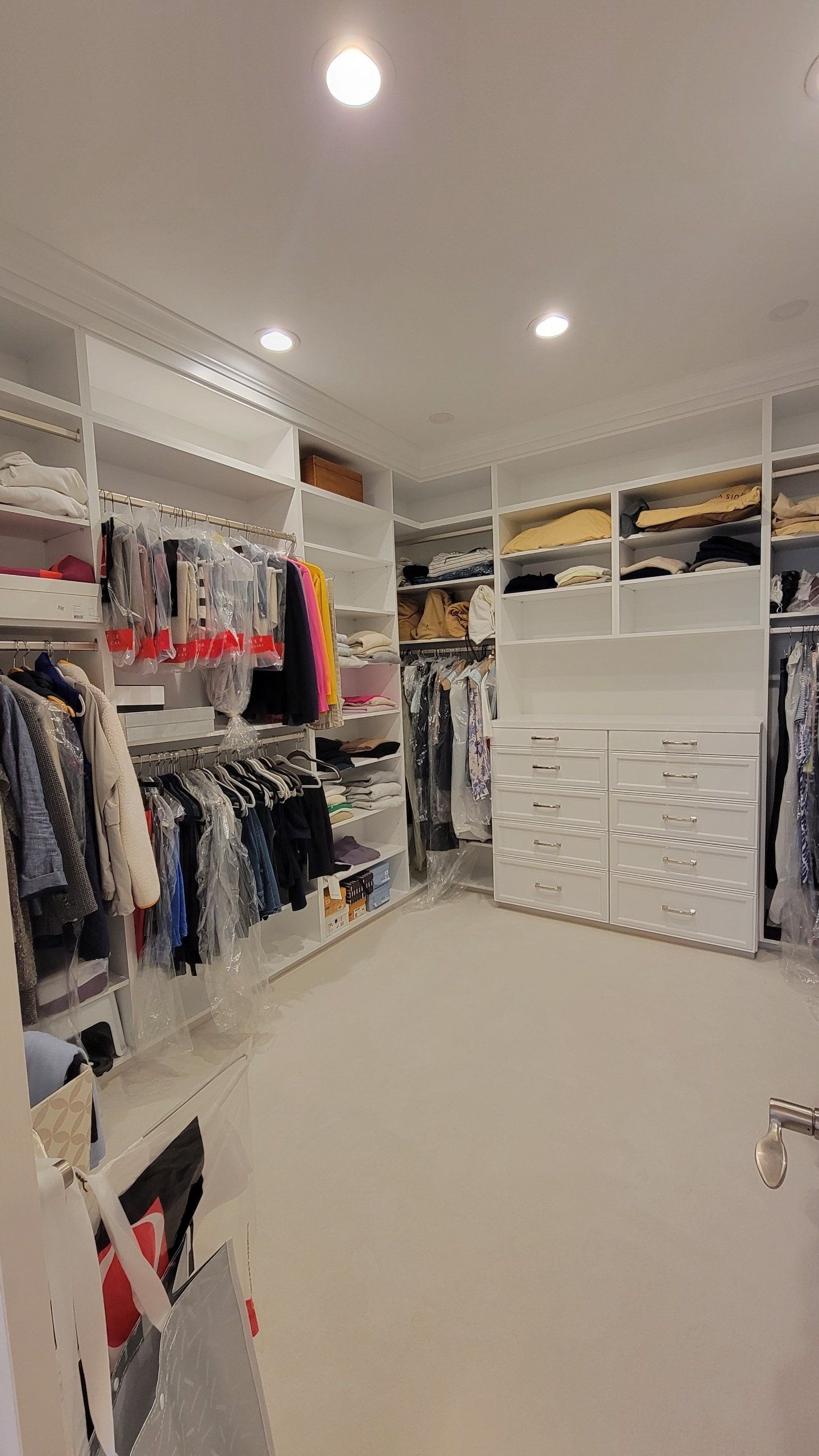 A large walk in closet filled with lots of clothes