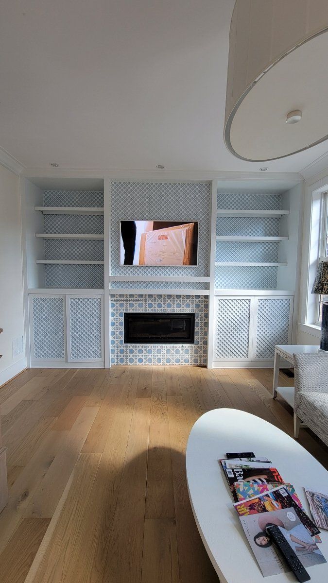 A living room with a fireplace and a flat screen tv