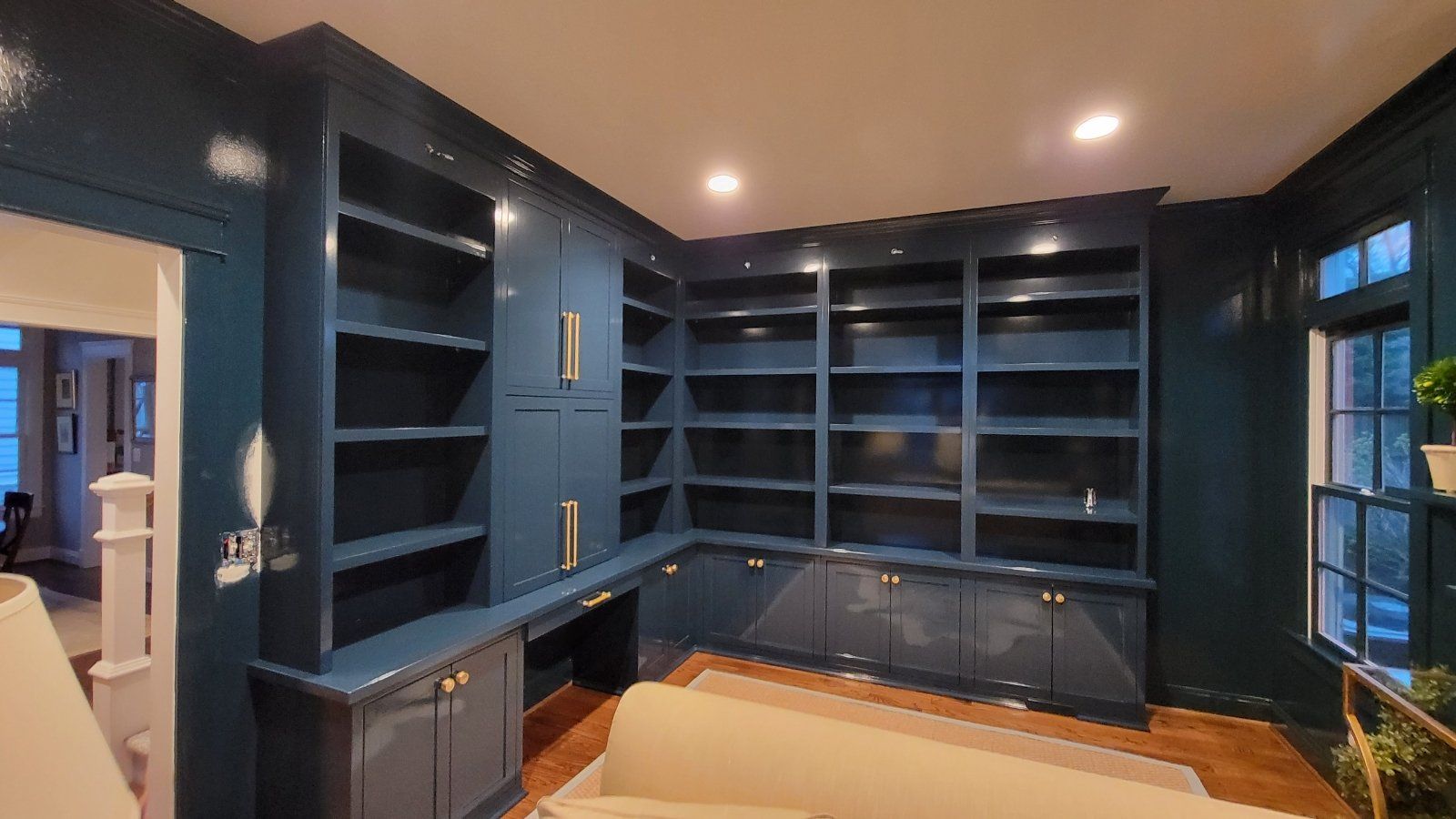 A living room with lots of shelves and cabinets