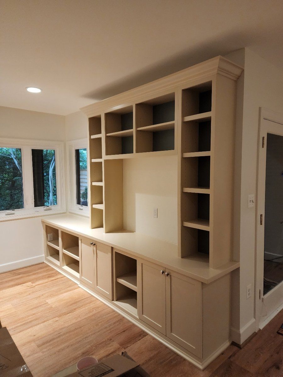 A living room with lots of shelves and cabinets
