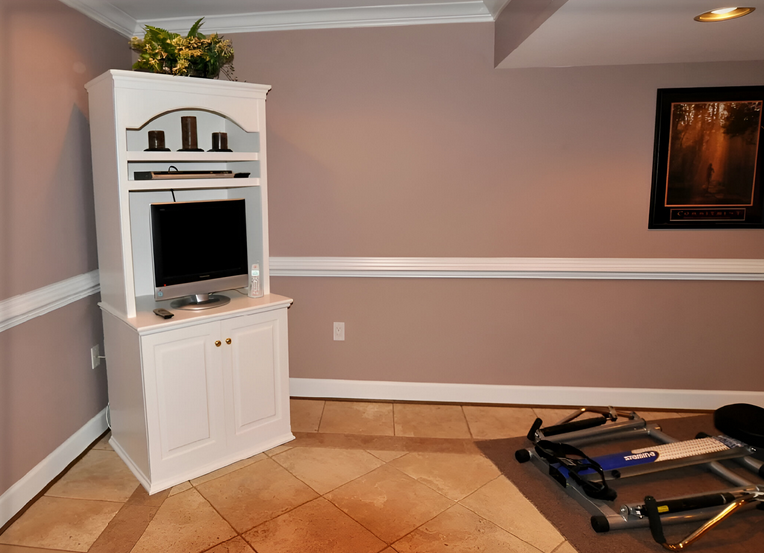 A white entertainment center with a flat screen tv