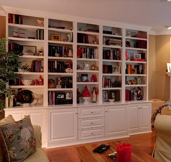 A living room with lots of shelves and a candle on the table