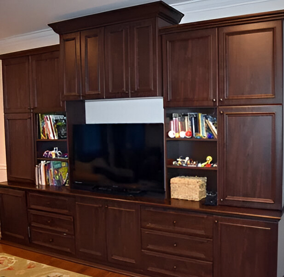 A living room with lots of cabinets and a flat screen tv