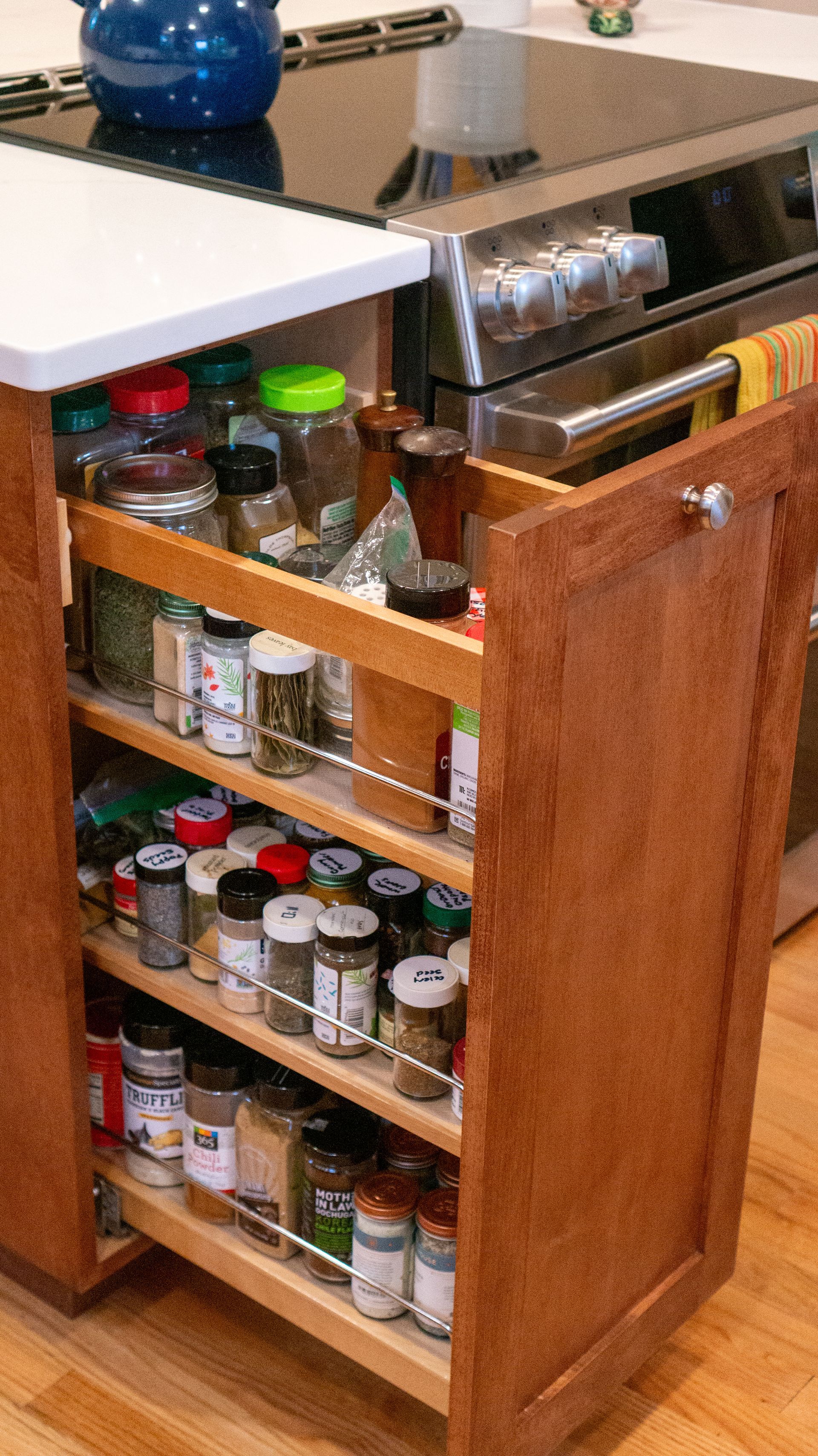 A picture of a pull out pantry in a kitchen