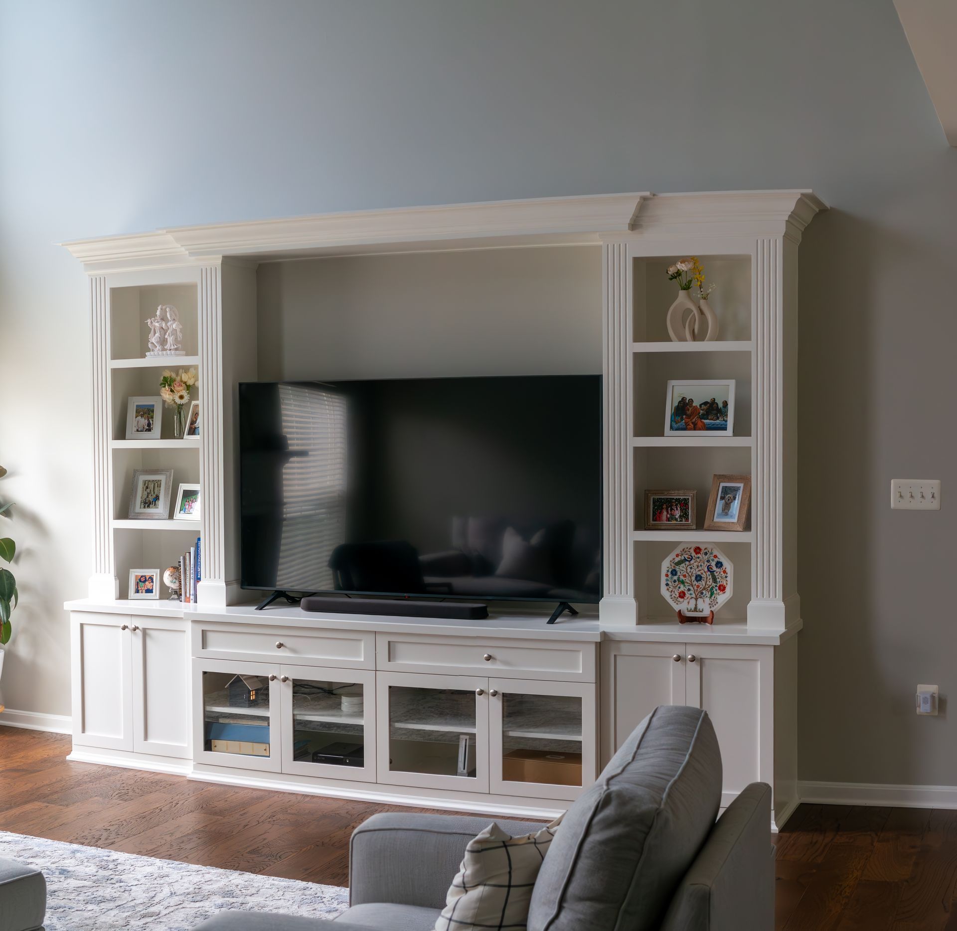 A white entertainment center with a flat screen tv