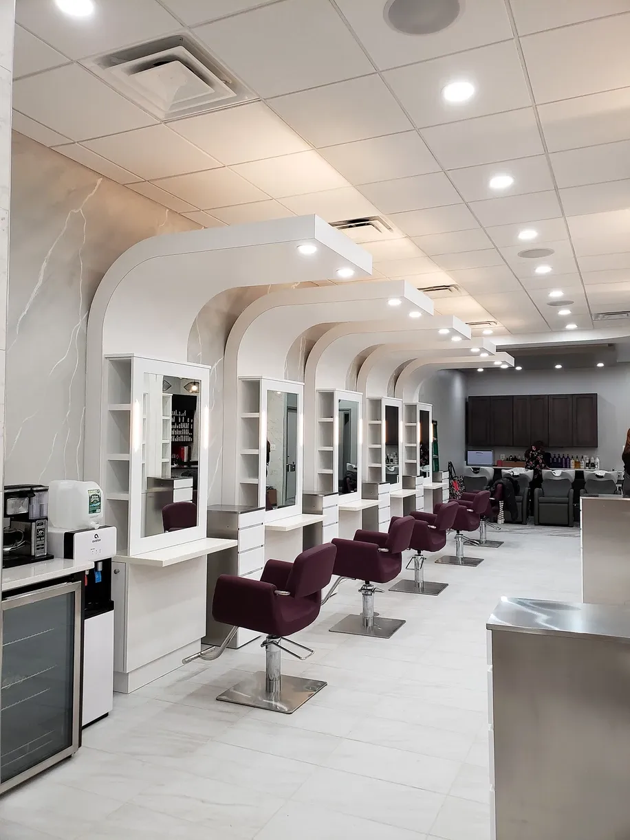 A hair salon with a lot of chairs and mirrors