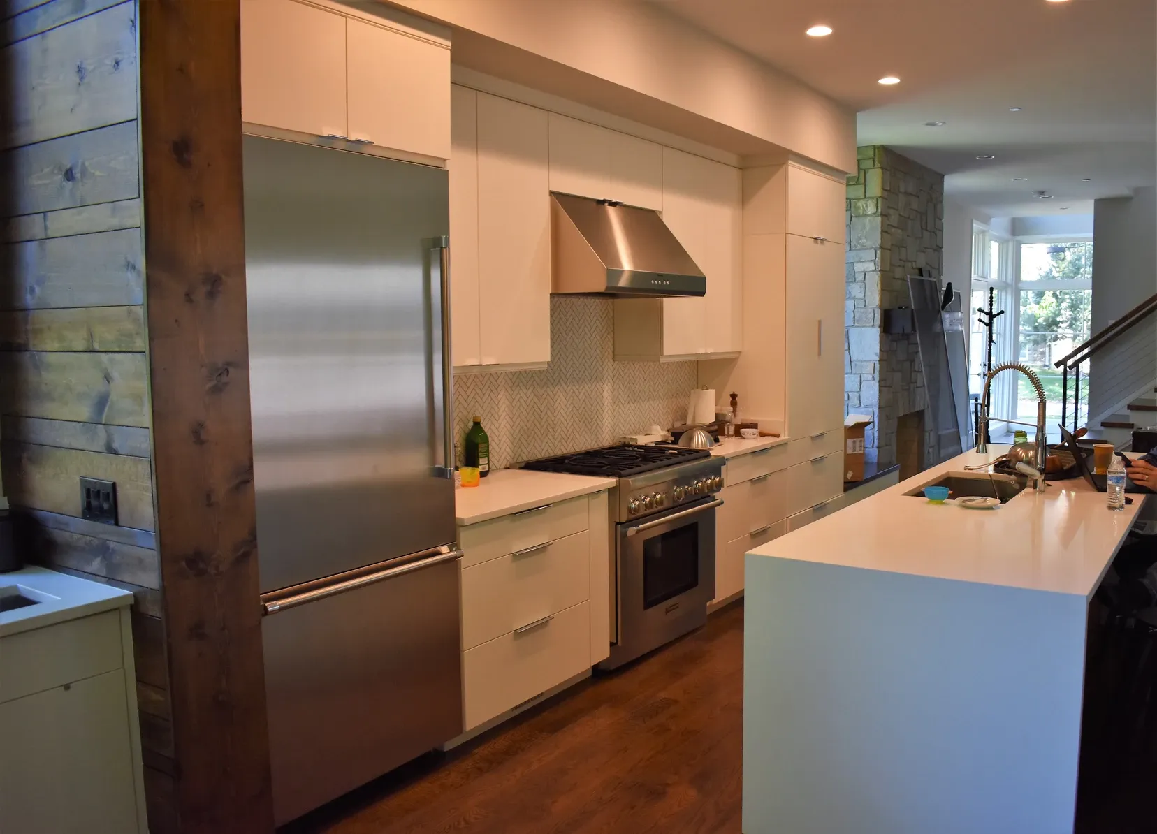 A kitchen with stainless steel appliances and white cabinets