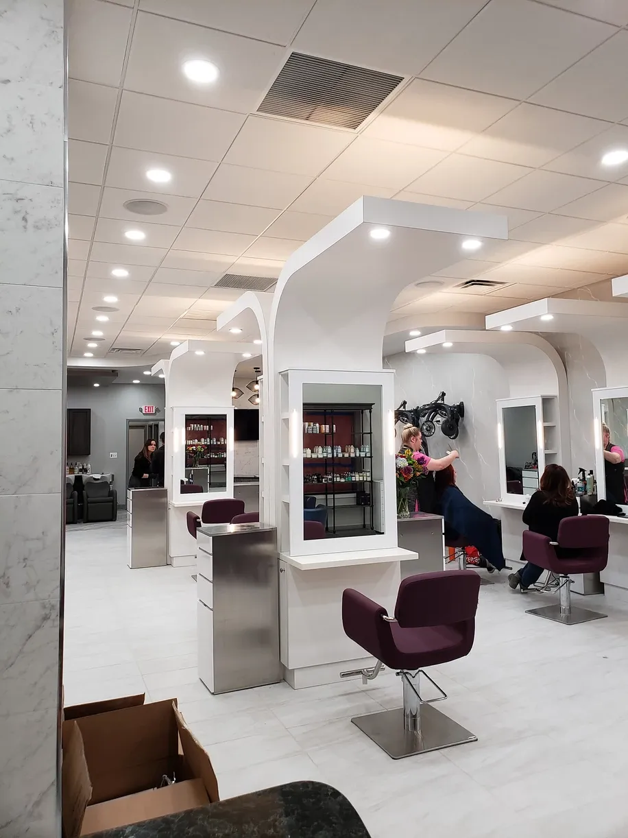 A woman is getting her hair done in a salon