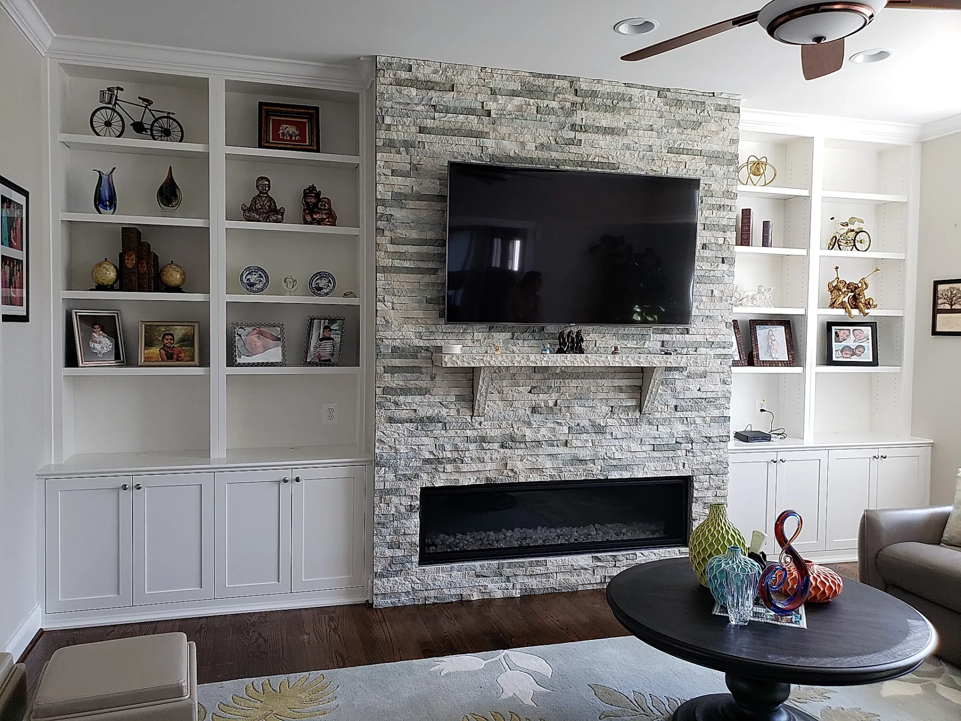 A living room with a fireplace and a flat screen tv