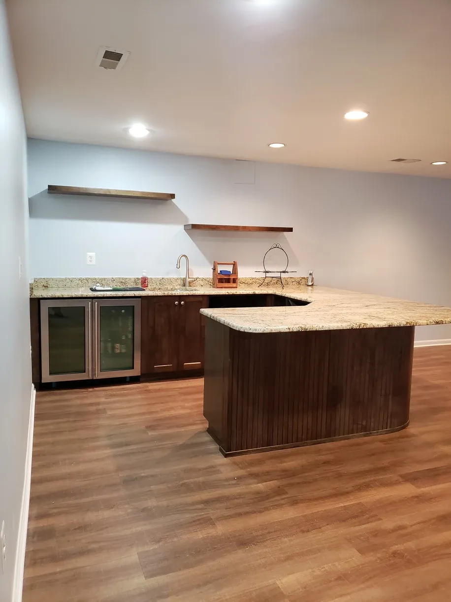 An empty kitchen with a large island in the middle