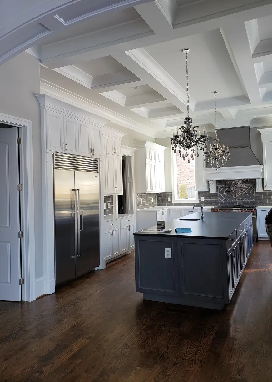 A kitchen with a large island and stainless steel appliances