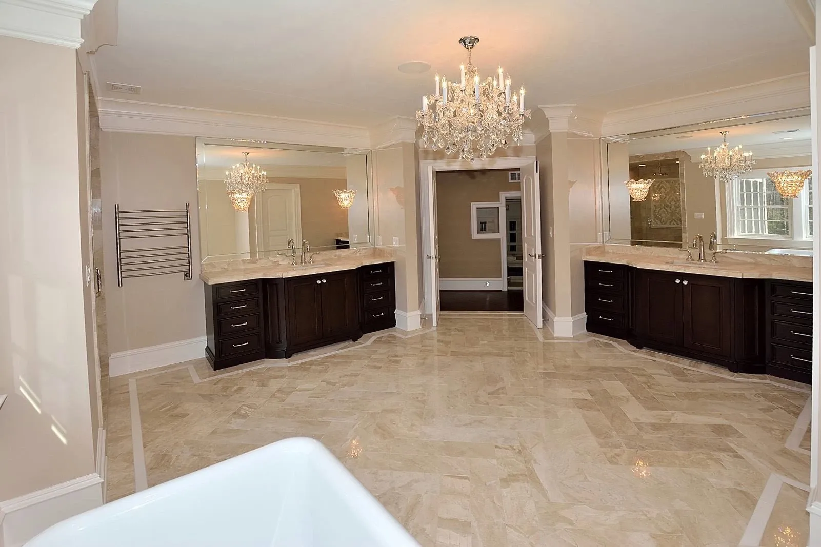 A bathroom with two sinks and a chandelier hanging from the ceiling