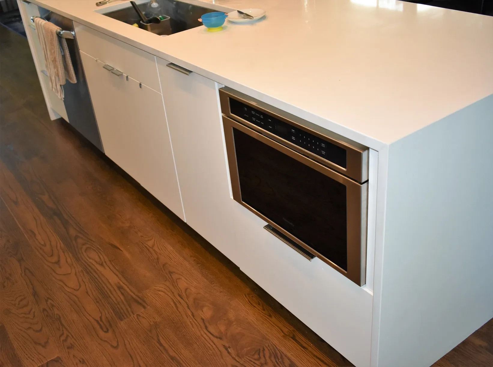 A kitchen with a white counter top and a black oven