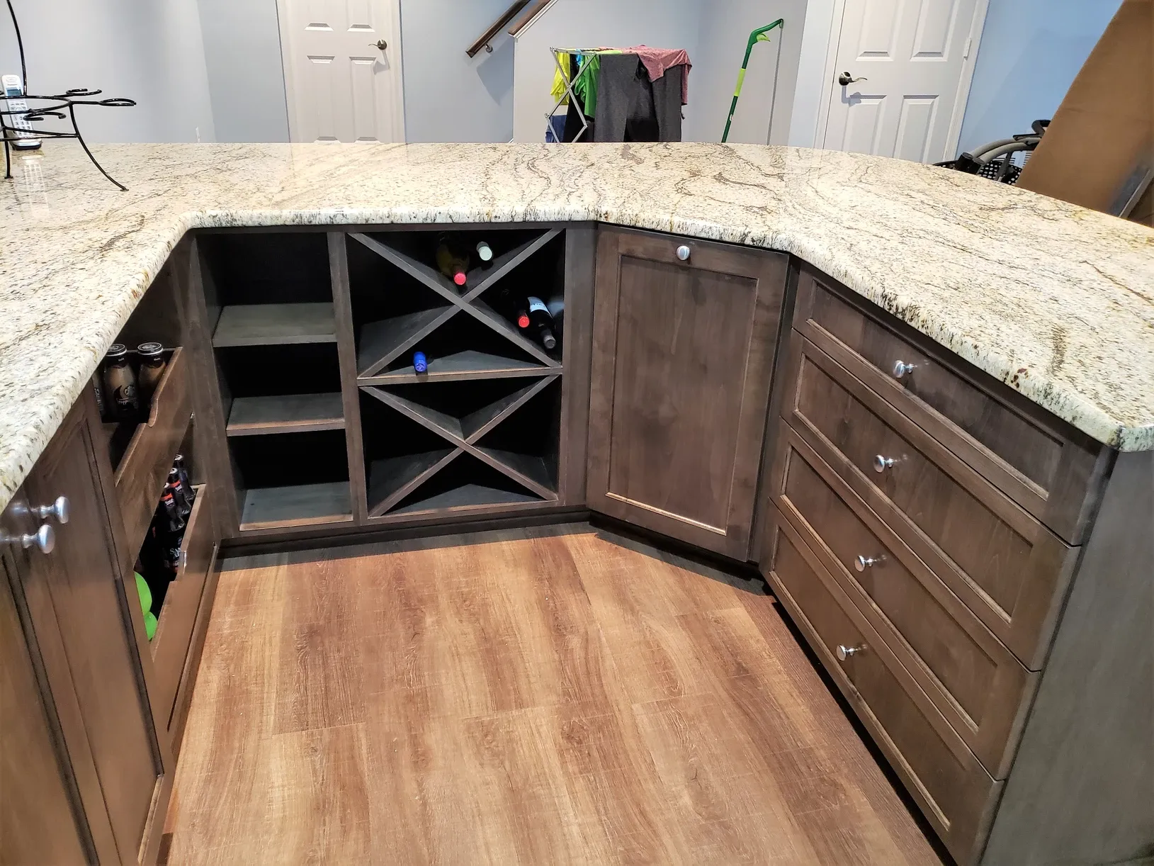 A kitchen with a wine rack and a granite counter top