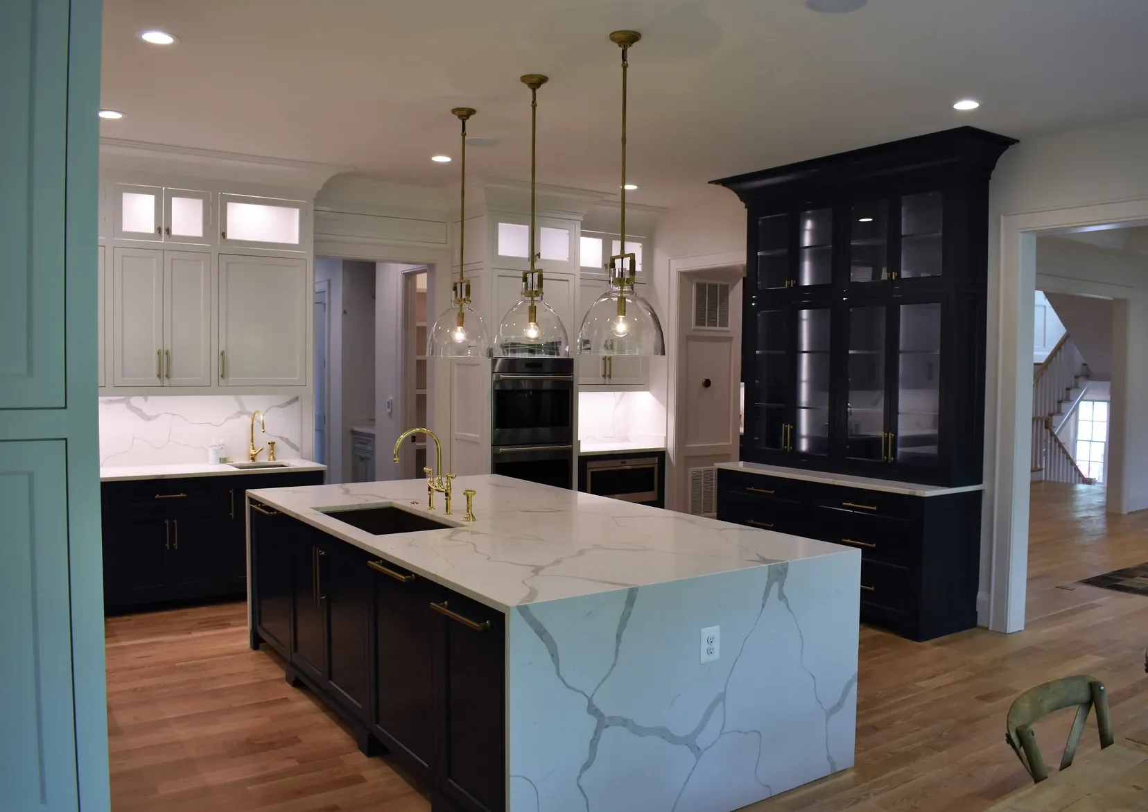 A kitchen with black cabinets and white counter tops