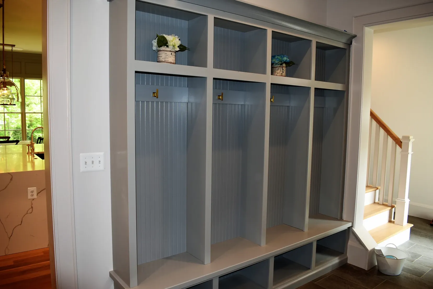 A gray locker with a vase of flowers on the shelf