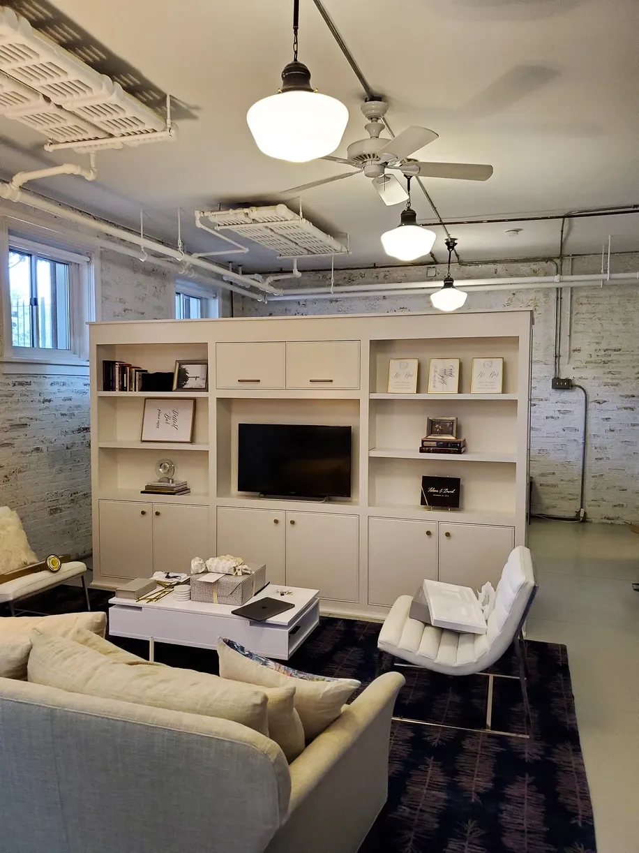 A living room with a couch a chair and a flat screen tv