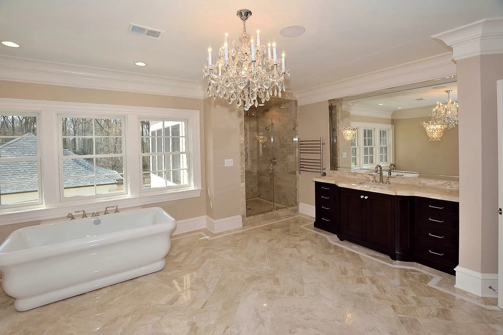 A bathroom with a bathtub and a chandelier hanging from the ceiling