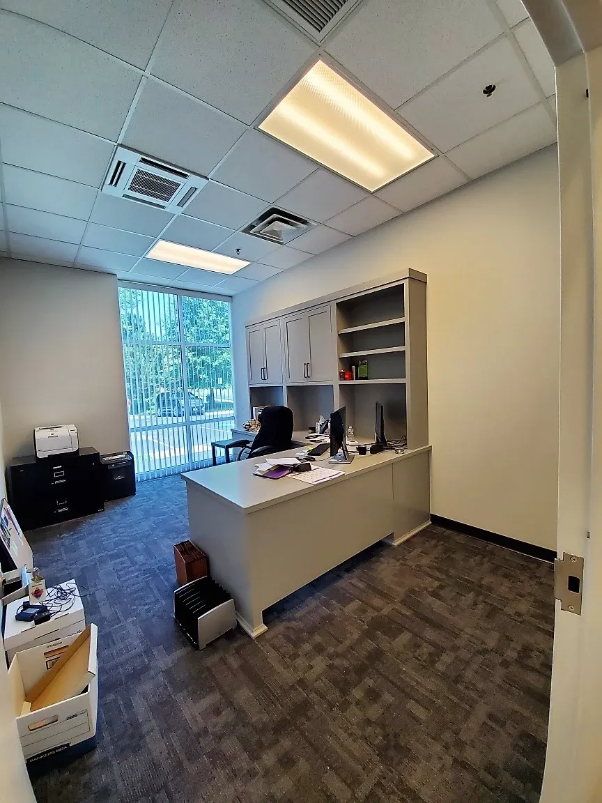 An office with a desk and a computer on it