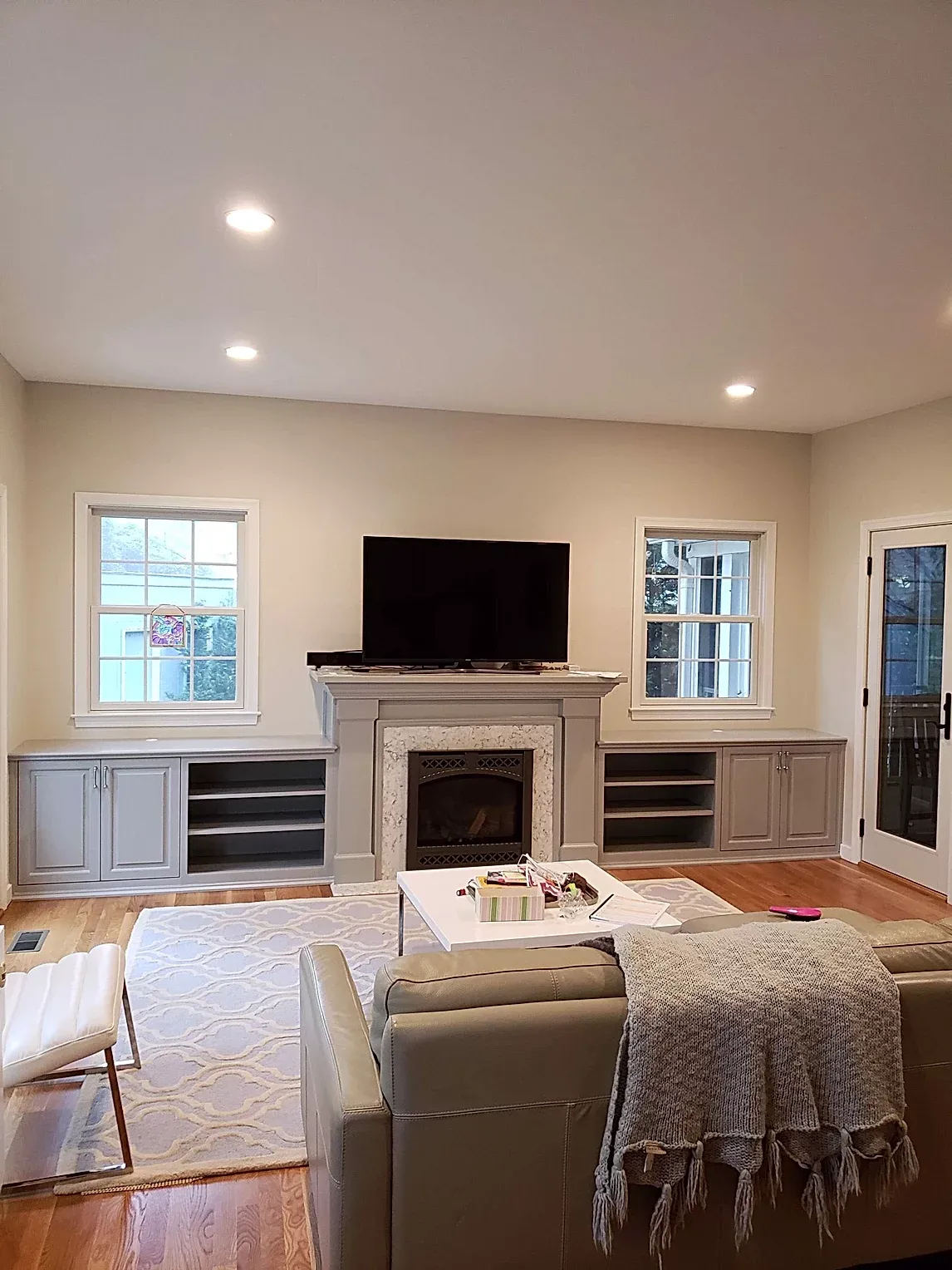 A living room with a fireplace and a flat screen tv