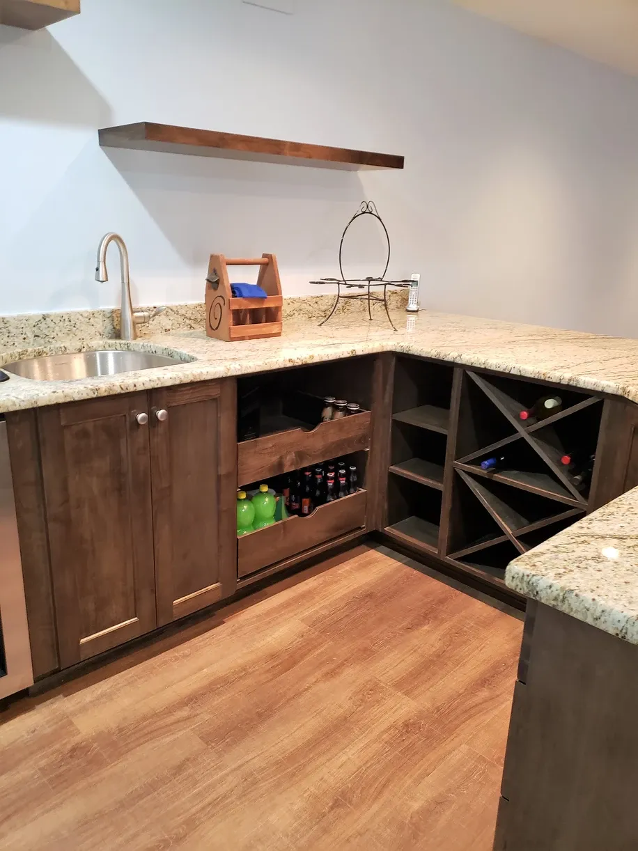 A kitchen with granite counter tops and wooden cabinets