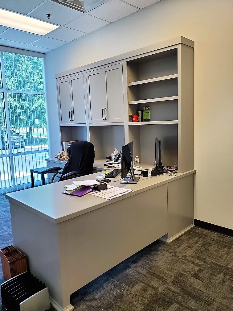 An empty office with a desk and a chair
