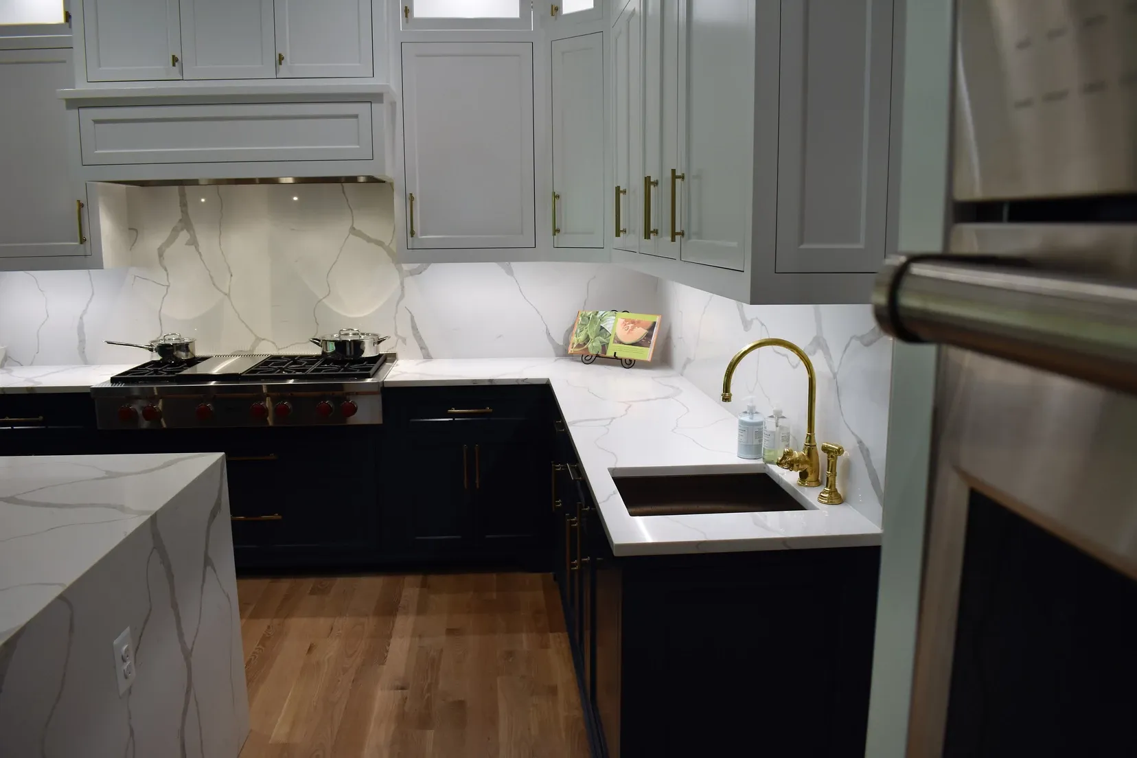 A kitchen with black cabinets and white counter tops