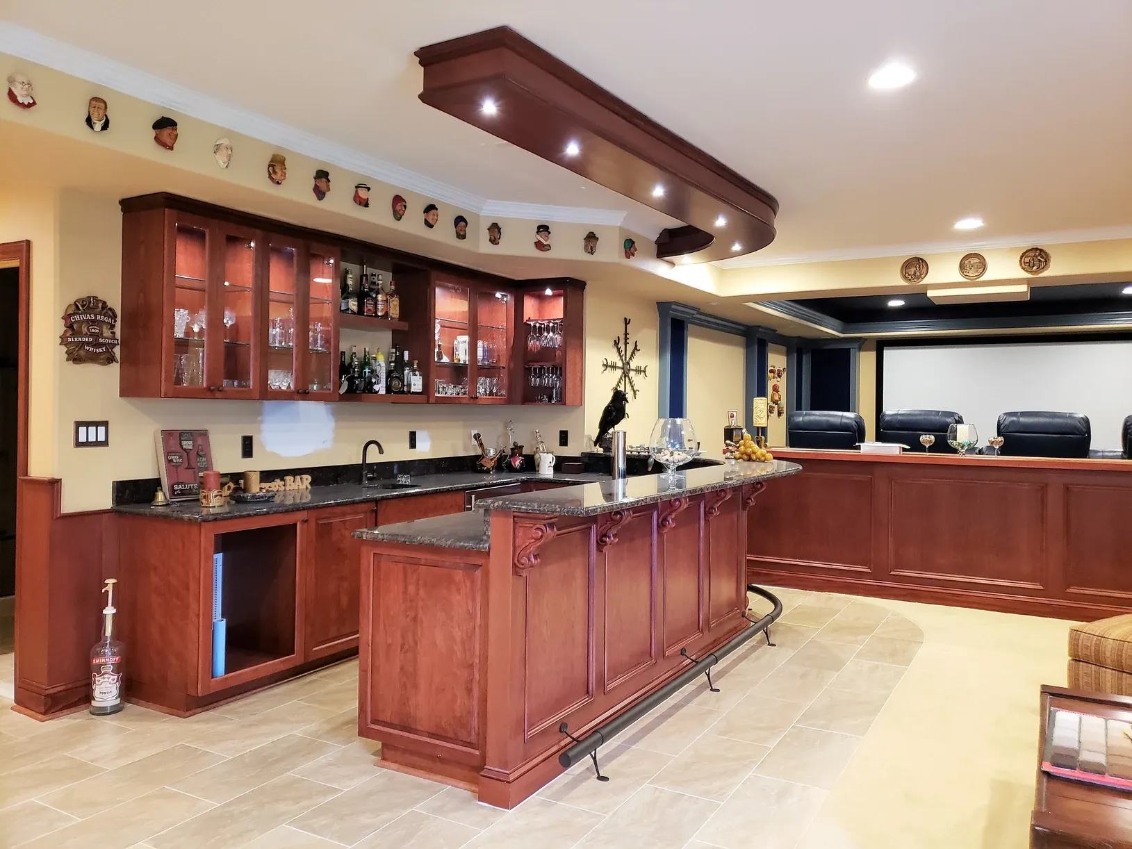 A kitchen with a bar and a display of bottles