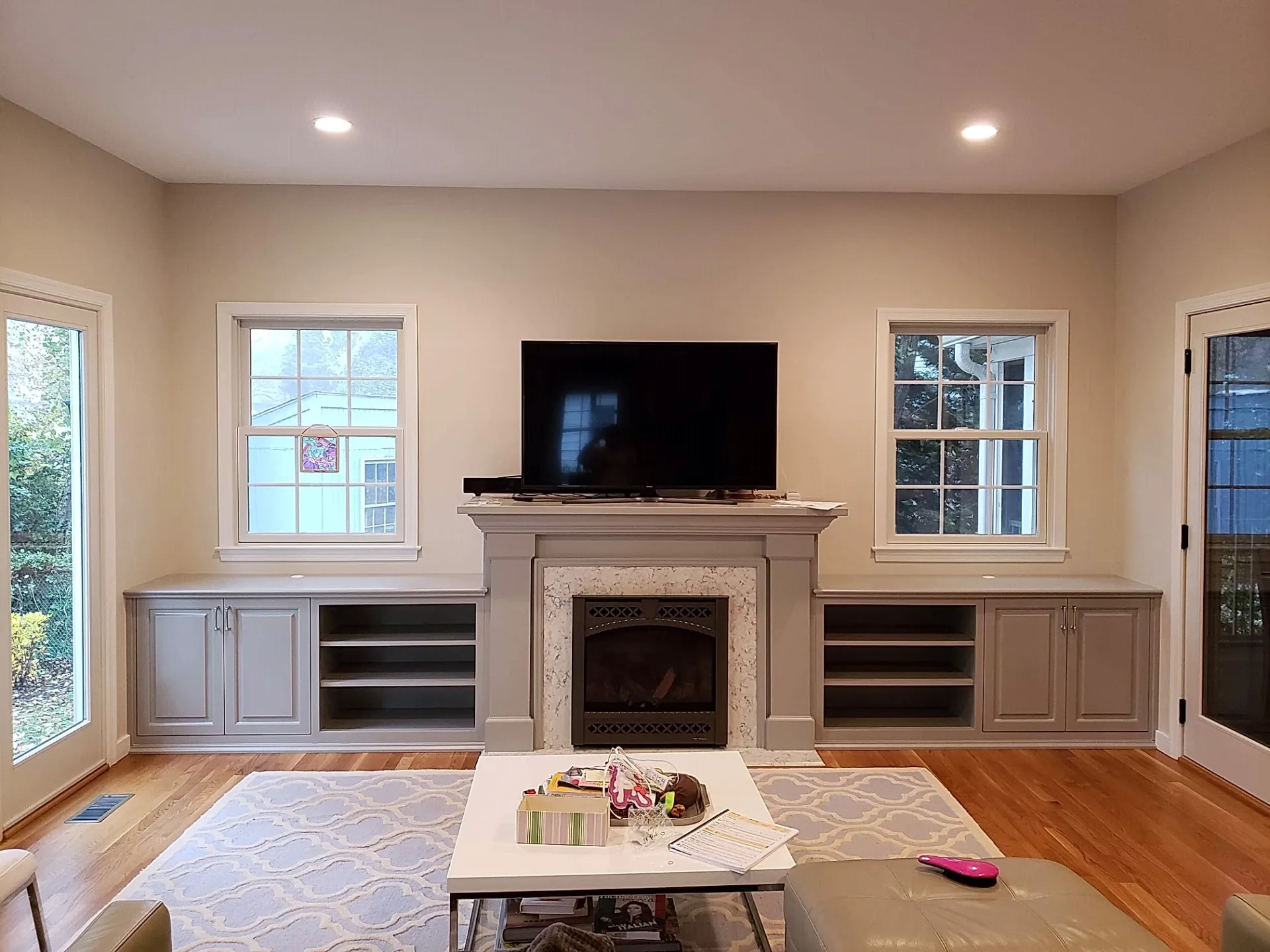 A living room with a fireplace and a flat screen tv