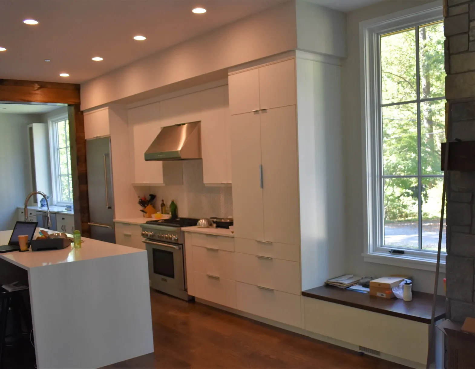 A kitchen with white cabinets and stainless steel appliances