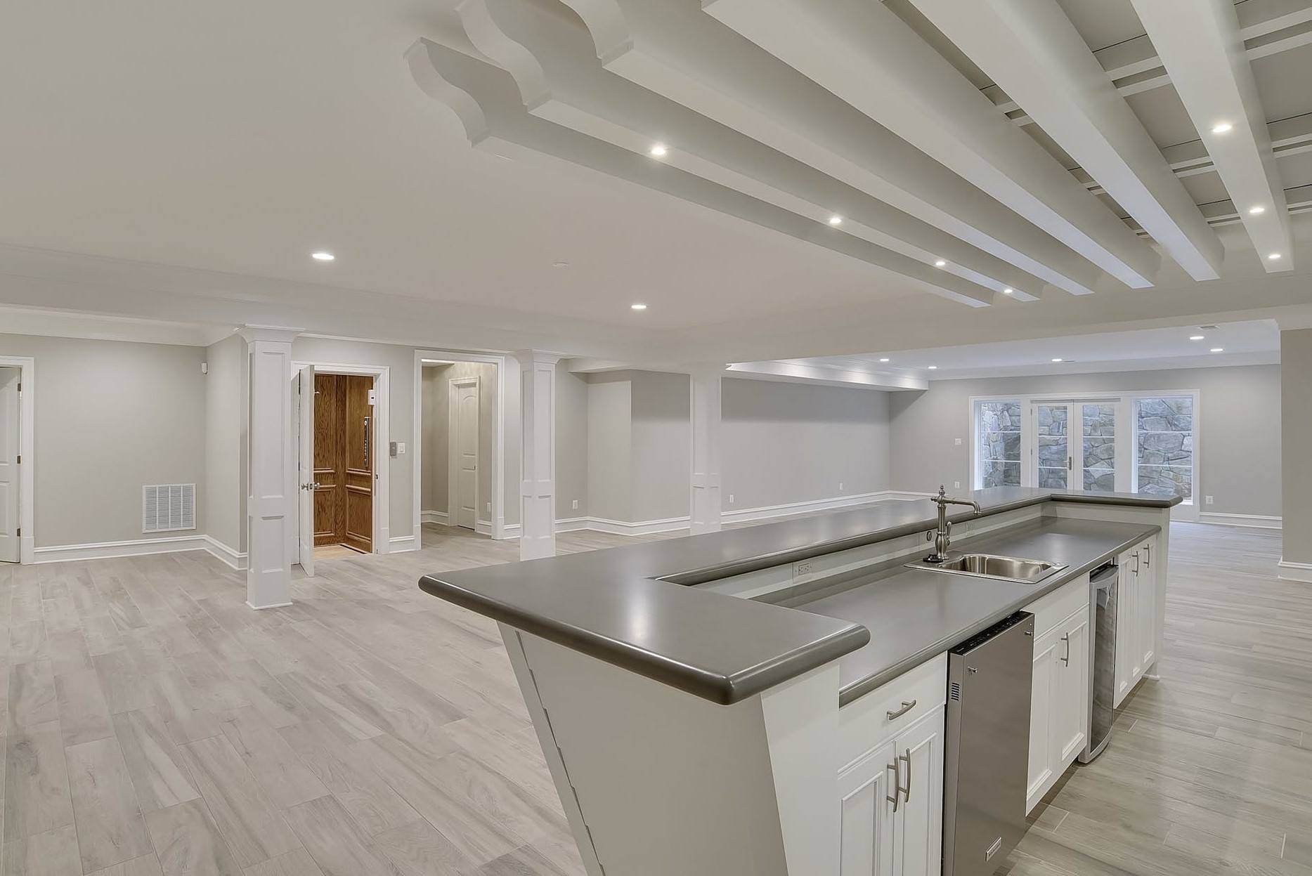 An empty kitchen with a large island and a sink