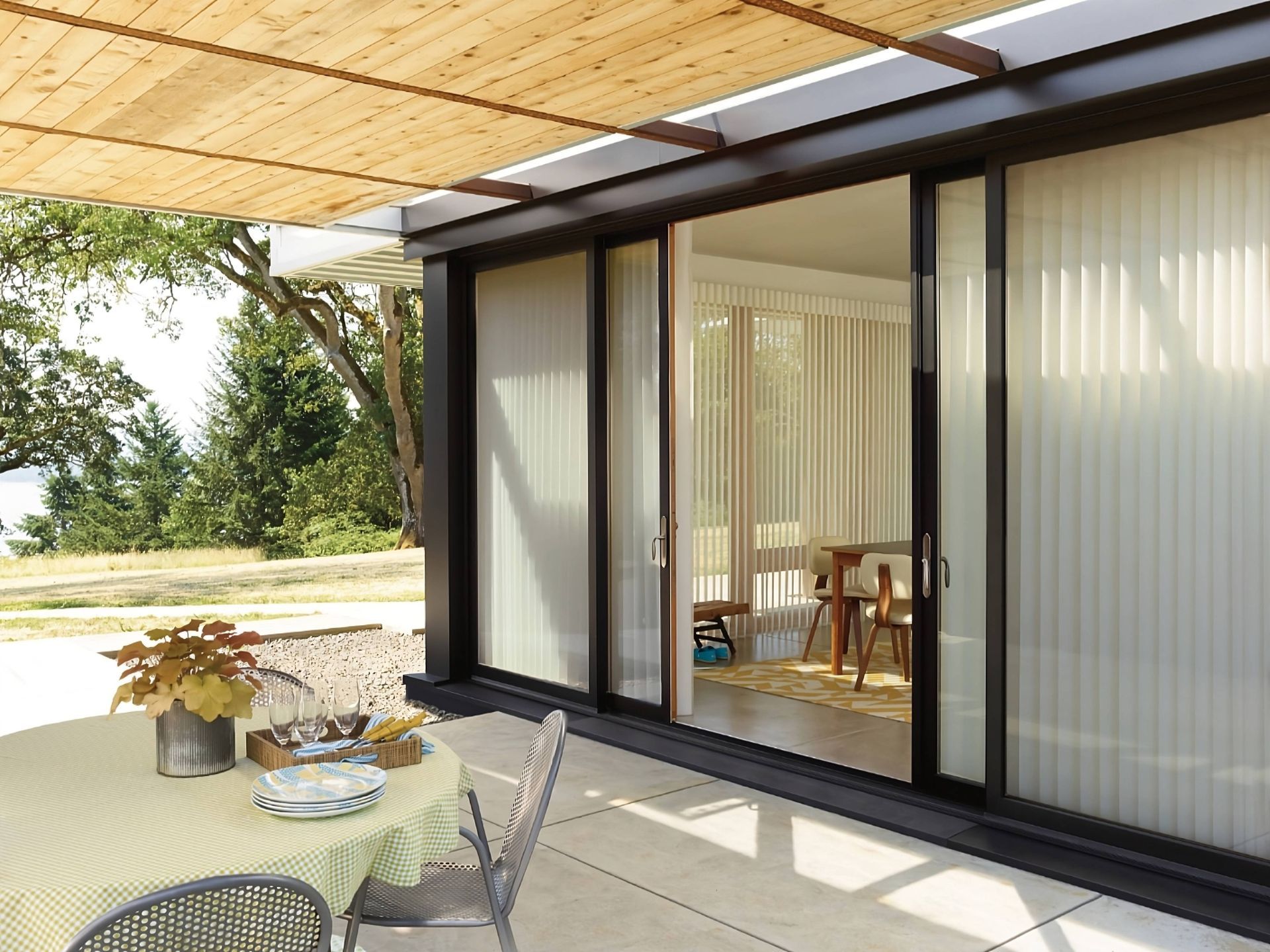 Hunter Douglas Luminette® Sheer Panels on a sliding door leading out from a dining room near Lakewoo