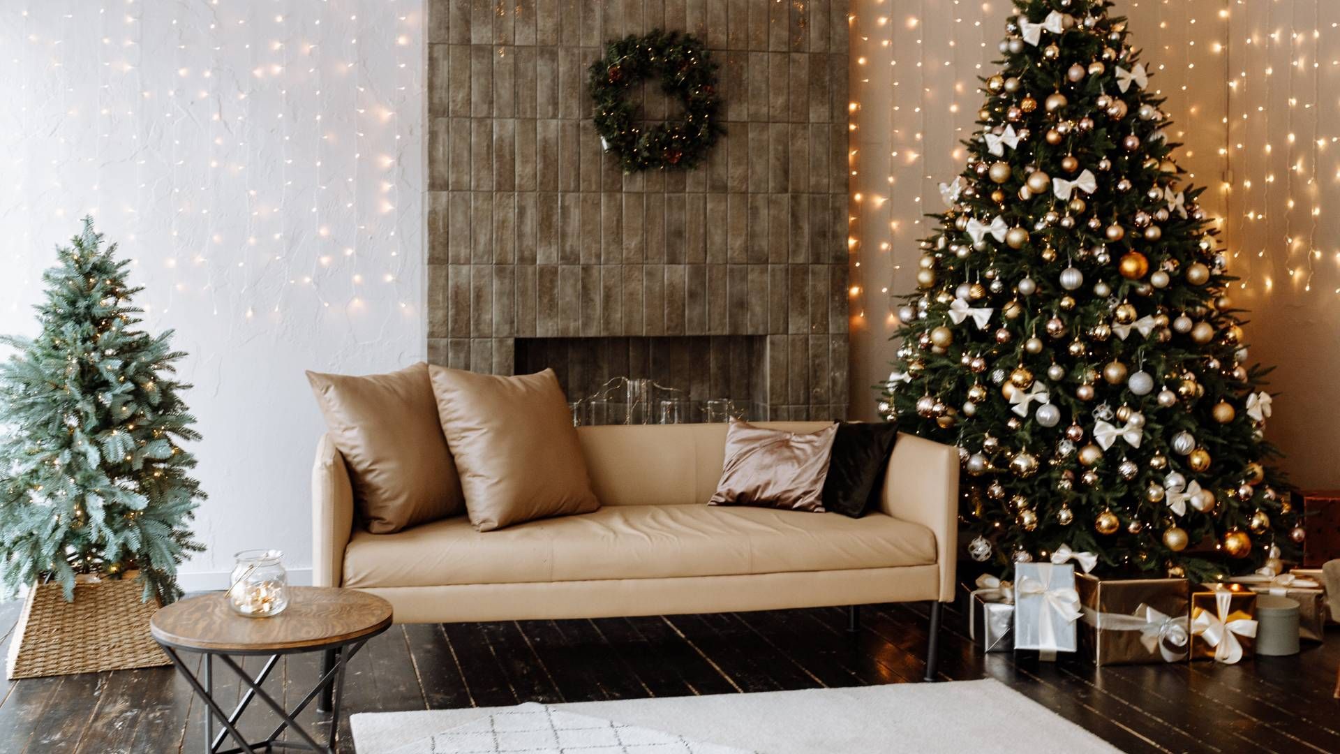 A stylish and cozy living room with a faux leather couch in front of a fireplace at Divine Interiors