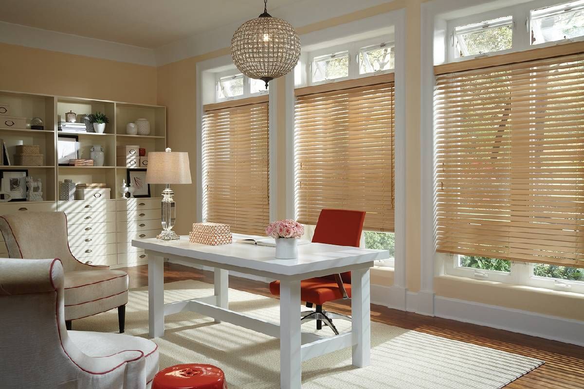 Brightly lit home office with many windows dressed with Hunter Douglas Parkland® Wood Blinds near Sarasota, FL