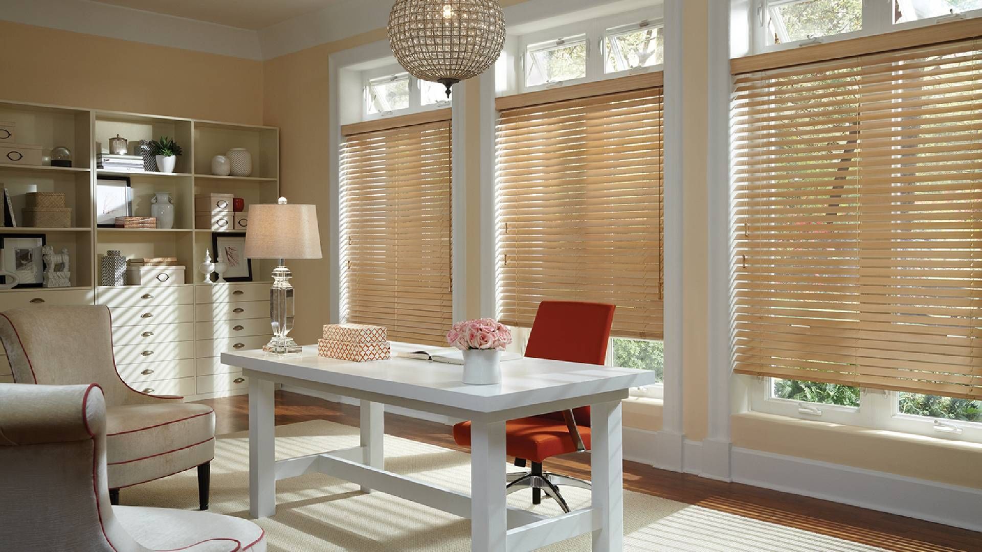 Brightly lit home office with many windows dressed with Hunter Douglas Parkland® Wood Blinds near Sa