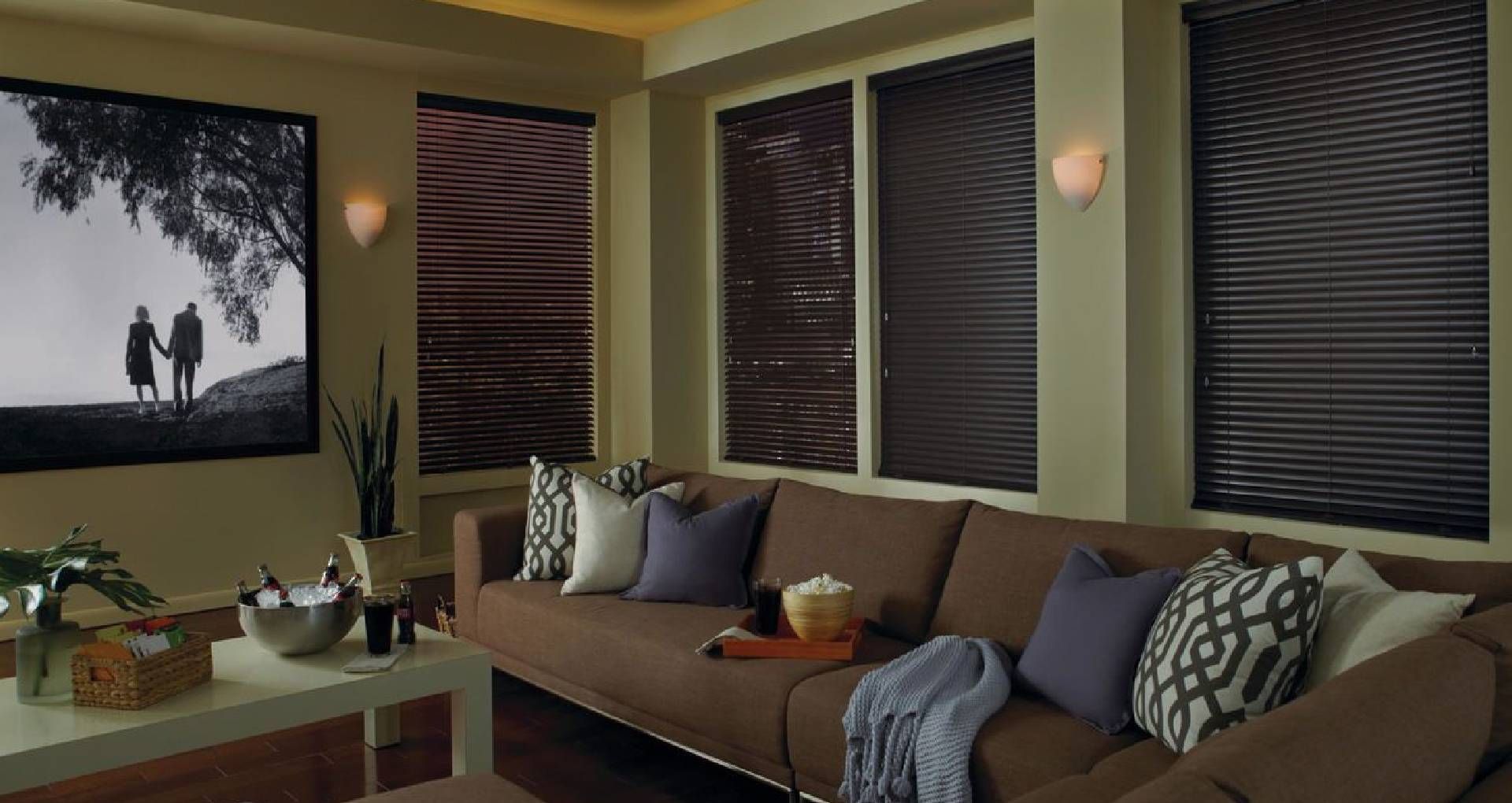 Comfortable living room with a large couch and Modern Precious Metals® Mini Blinds on the windows ne