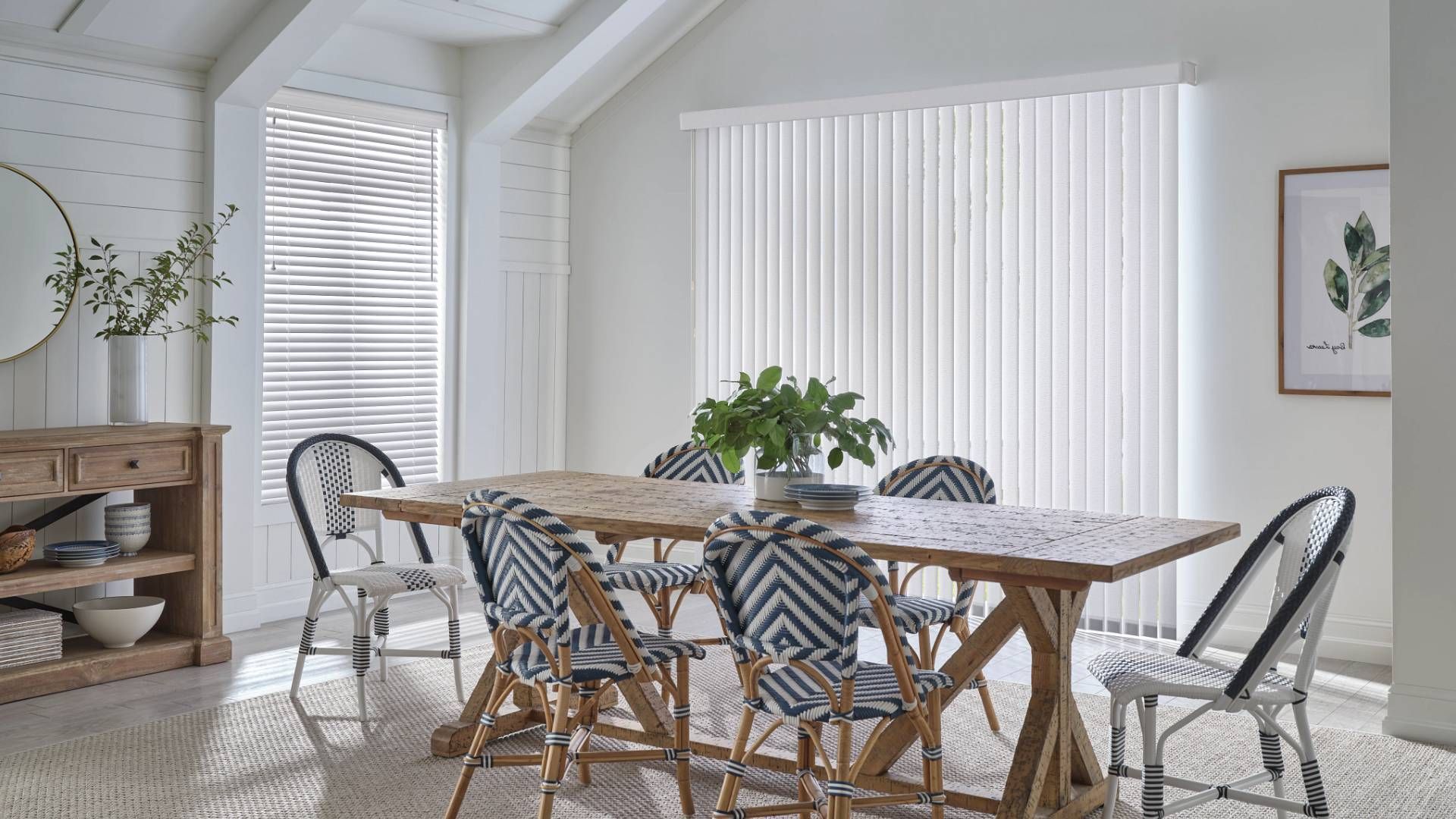 Modern kitchen with a wooden table and sliding glass door covered with Hunter Douglas Vertical Solut