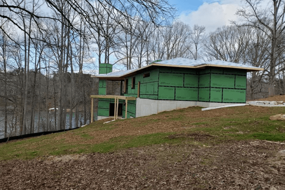 Construction of a modern house on a grassy hill